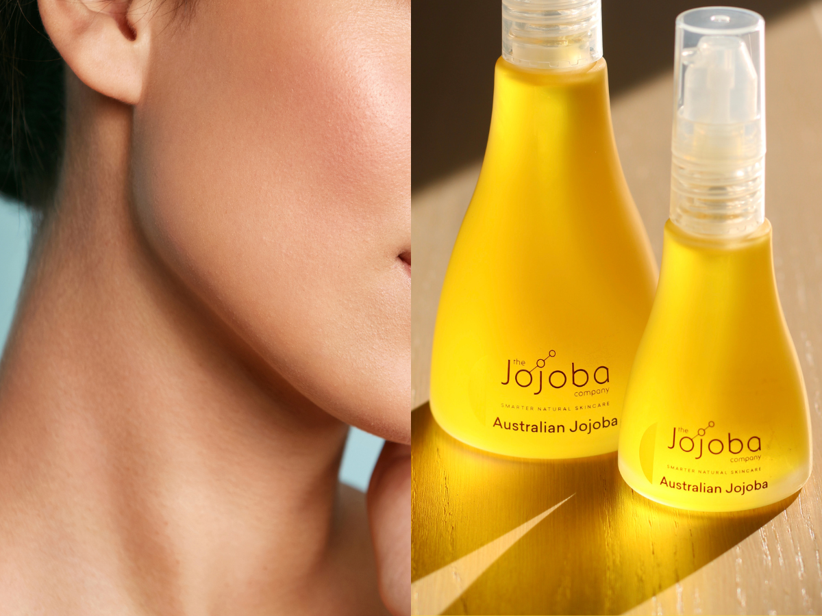 Two bottles of 'The Jojoba Company' skincare oil on a reflective surface.