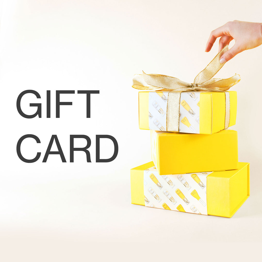 A hand unties a gold ribbon on a yellow gift box with "GIFT CARD" text to the side.