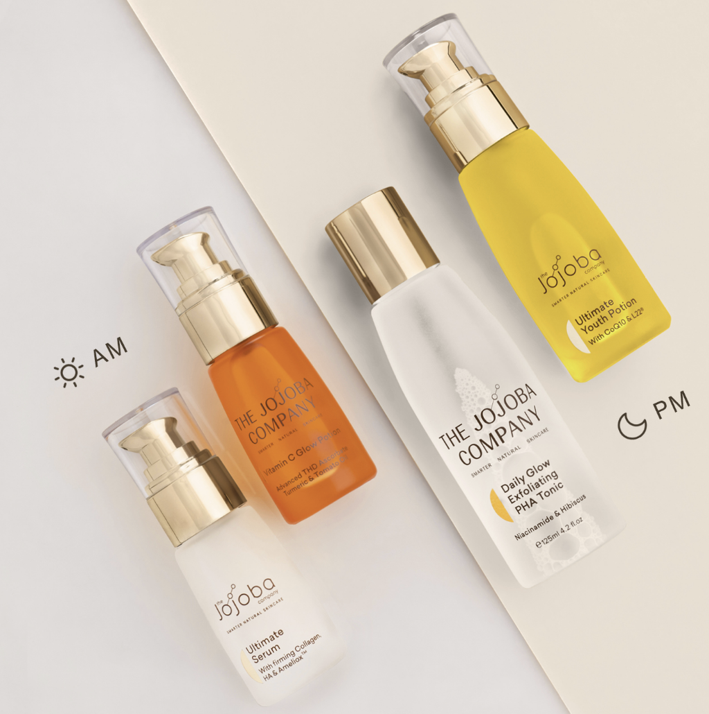 Four skincare products by The Jojoba Company on a dual-tone background with AM/PM indicators.