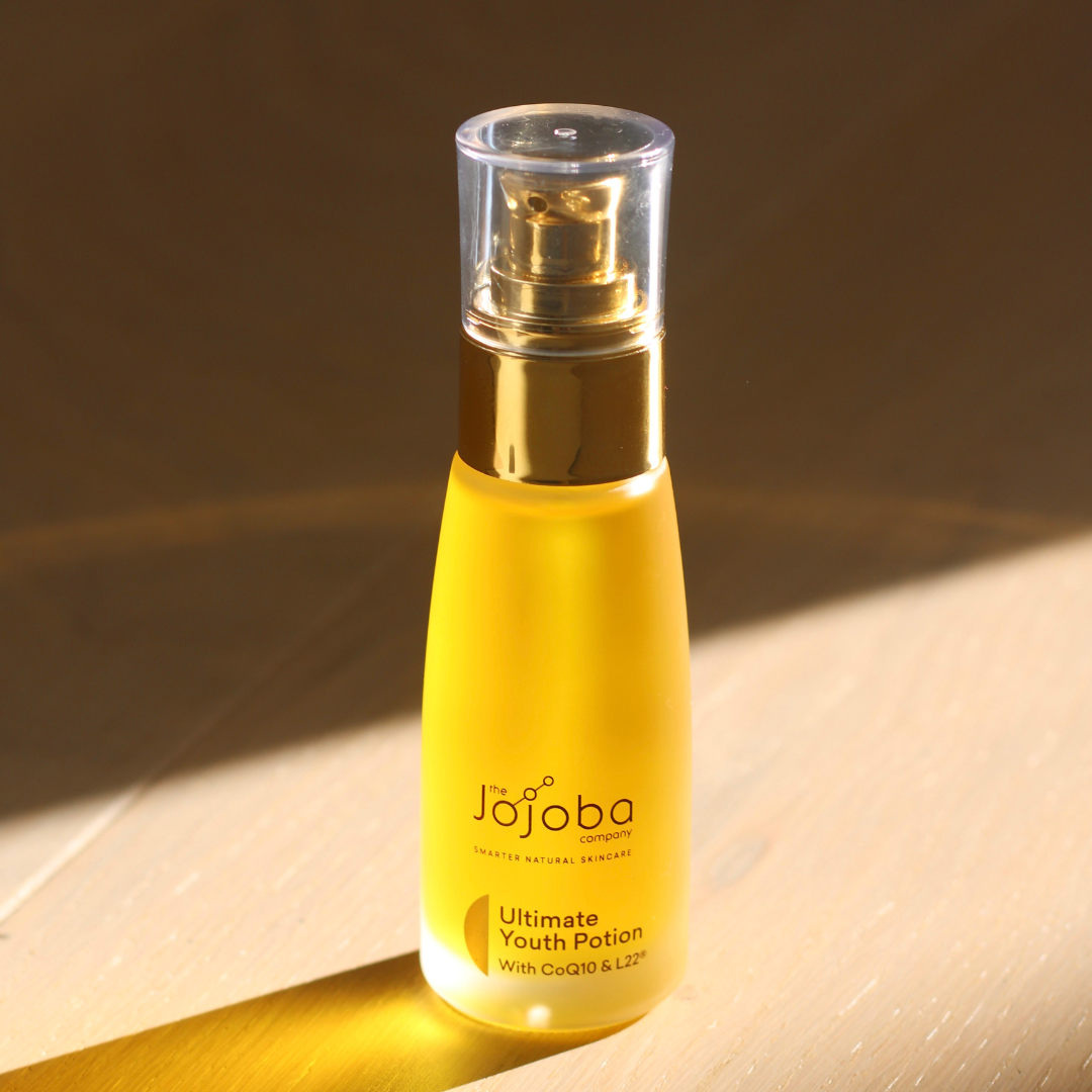 Bottle of Jojoba Ultimate Youth Potion skincare oil in sunlight.